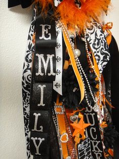 an orange and black halloween decoration hanging on a wall