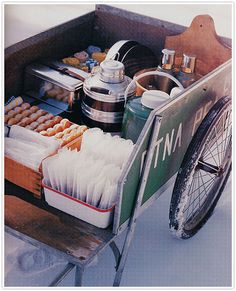 a wagon filled with lots of food and cooking utensils