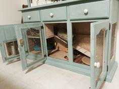 a blue cabinet with several cages in it