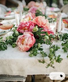 a table with flowers and plates on it