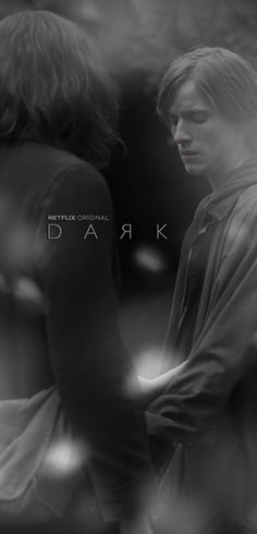 two people standing next to each other in front of a black and white background with the words dark on it