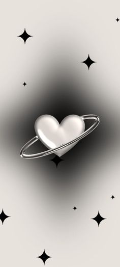 a heart shaped object floating in the air surrounded by stars