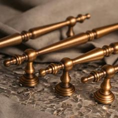 four antique style brass faucets on a bed