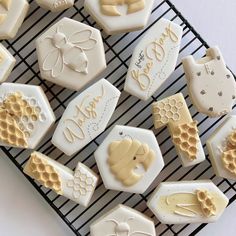 some cookies that are sitting on a cooling rack with honeycombs and bees around them