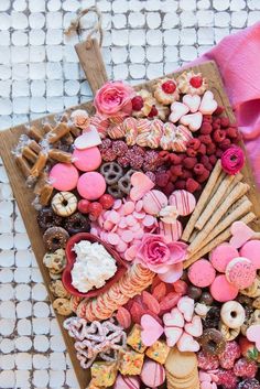 a tray filled with lots of different types of cookies and pastries on top of a table