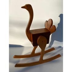 a wooden rocking toy with an ostrich design on it's back legs