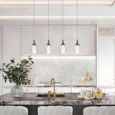 a kitchen with marble counter tops and white chairs, gold accents on the backsplash