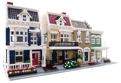 there is a lego house with many windows and balconies on the top floor