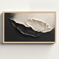 a black and white painting on the wall with a large leaf in it's center