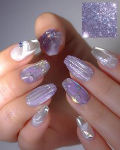 a woman's hand with some purple and white nails