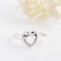 About item Item :-Custom  Heart knot ring. Ring size :- Chose from variation (Custom size accepted) Material  :- 925 Sterling silver Purity  :- 92.5 Title: Love Knot Ring, Heart Knot Ring, Infinity Heart Ring, 925 Sterling Silver ring, Love knot jewelry, Promise ring, Romantic Gift, Gift for Her, Rings For Women, Initial Rings, Engraved Ring, Valentine's day gift, Promise ring, Anniversary gift Description:- We use 925 sterling silver to making jewelry. We accept all types of custom & personalized order. Please send us a message if you are interested in a custom creation. Shipping profile:- We ship all order within 3-5 days. But custom order takes time. Customer service :- If you have any question about our products & services, feel free to contact us. We do always best for our customers O Sterling Silver Infinity Rings For Valentine's Day, Sterling Silver Infinity Heart Ring For Wedding, Sterling Silver Infinity Heart Wedding Ring, Heart Knot Ring, Cheap Promise Rings, Initial Rings, Knot Jewelry, Heart Knot, Love Knot Ring