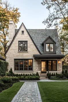 a brick and stone house with large windows