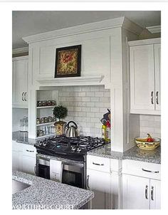 a kitchen with white cabinets and granite counter tops