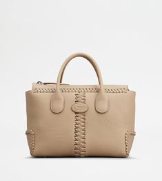 Refined piping and tubular handles characterize this elegant shopping bag, with Tod's logo stamped on the front. Featuring an internal pouch and a removable shoulder strap, this iconic style is crafted in exposed grain leather. To accompany you r everyday outfit with class and femininity. Designer Satchel With Rolled Handles For Daily Use, Designer Rectangular Satchel With Rolled Handles, Luxury Rectangular Satchel With Rolled Handles, Designer Rectangular Bag With Rolled Handles, Designer Shoulder Bag With Rolled Handles For Daily Use, Designer Satchel Tote With Rolled Handles, Designer Top Handle Satchel With Rolled Handles, Formal Beige Bags With Rolled Handles, Designer Beige Shoulder Bag With Rolled Handles