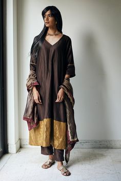 Bark brown kurta with floral block print on the sleeves and cutdana embellishment. Comes with straight pants.
Component: 2
Print
Neckline: V neck
Sleeve Length: Half
Fabric: Chanderi
Color: Brown
Gold trim at the hem
Block printed pant
Side slits
Note: Dupatta worn by the model is not for sale - Aza Fashions Plain Kurti Designs, Silk Kurtas, V Neck Kurta, Indian Women Fashion, Latest Dress Design, Desi Wear, Womens Trendy Dresses, Kurta Designs Women, Dress Indian Style