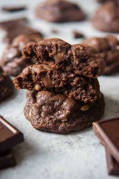 chocolate cookies stacked on top of each other with one bite taken out of the middle