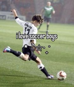 a man kicking a soccer ball on top of a field with the words i love soccer boys