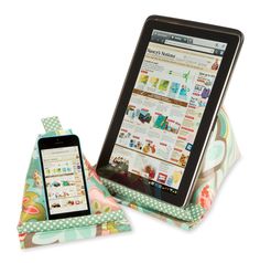 an ipad and tablet sitting on top of a flowered cloth covered case with polka dots