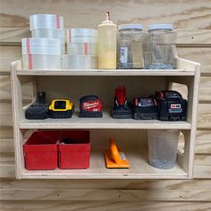 a shelf filled with different types of tools and storage containers on top of wooden shelves