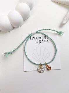 🐚 Sandy toes and sea shell dreams! This beautiful summer bracelet features 18K gold plated charms in a handmade adjustable glitter cotton rope cord. 😎 ITEM DETAILS  🌴 18K Gold plated charms 🌴 Cotton cord rope 🌴 Nylon cord All of our bracelets are handmade with high quality materials. The listing is for one bracelet, images showing more than one are an example of how they would look stacked with other bracelets. If you have any questions, please feel free to message me. CARE TIPS 🤍 Keep your jewelry dry and away from perfumes or any harsh chemicals 🤍 Store your jewelry separately, and avoid wearing it if you are going to work out. Thank you so much for visiting my shop! 🤍 Have fun creating your favorite combinations and enjoy your new jewelry!  Follow me on instagram: @tropicalpink_ Shell Charm Bracelet, Gold Shell Bracelet For Vacation, Gold Shell Strand Bracelets, Gold Shell-shaped Bracelet For Vacation, Gold Charm Bracelet With Starfish For Beach, Adjustable Gold Charm Bracelet With Starfish Charm, Adjustable Gold Beaded Shell Bracelets, Gold Strand Bracelet With Ocean-inspired Style, Resizable Gold Beaded Bracelets For The Beach