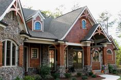 a house with stone and wood trimmings on the front, side and sides