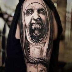 a person with a tattoo on their arm has a creepy face and head in the background