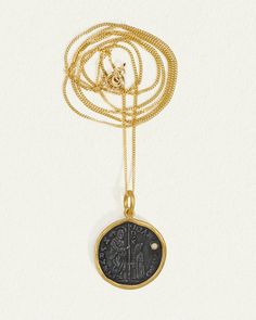 Revel in the rich history and opulent design of the Regis Necklace. Set within the warmth of 24k yellow gold is an intriguing coin of oxidised silver. Punctuated by a solitary natural diamond, this necklace depicts a coronation scene, while the reverse side shows a king and the word 'REGIS'.  
 Completing this two-toned diamond necklace is a 14k yellow gold curb chain. Coin Bracelet, Necklace Diamond, Diamond Guide, A King, Diamond Shop, Coin Necklace, Sapphire Engagement, Engagement Ring Wedding Band, Engagement Rings Sapphire