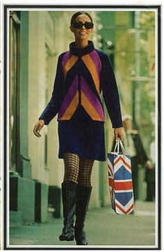 a woman is walking down the street with shopping bags in her hand and wearing boots