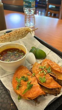 a plate with some food on it and a bowl of soup