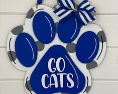 a blue and white dog paw with the words go cats on it