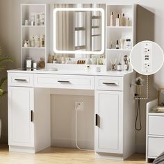 a white vanity with a mirror and lights on it next to a potted plant