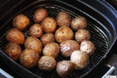 some meatballs are cooking in an air fryer on the grill, ready to be cooked