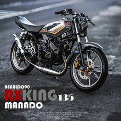 a black and gold motorcycle parked on the side of the road with words reading rx king mando