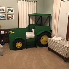 a green tractor bed sitting in the middle of a bedroom next to a window with curtains