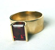 Vintage 14k Gold SKAL2.50Ct Mid Century Modernist Wide Tension Set Cocktail Ring Vintage 14k Gold SKAL2.50Ct Mid Century Modernist Wide Tension Set Cocktail Ring Click images to enlarge Description Offered today is a well-made, solid 14k yellow gold mid-century modernist  garnet ring, signed SKAL.  I set out to find out who stamps/ stamped their jewelry SKAL, and this trademark was used by the Skalet Jewelry Co. of NYC, with its inception in the 1940s.  As far as I can see, the trademark no longer exists.  (Many eBay sellers are incorrectly listing this SKAL stamp as belonging to a German designer, Hubertus Von Skal, but this is not his work.  A German ring would NOT have USA hallmarks of 14k; it would have German assay marks).  Anyway, I digress. This is a REALLY NICE RING and very unique Modernist Jewelry Rings, German Ring, Vintage Modernist Jewelry, Tension Setting, Vintage Cocktail Ring, Modernist Ring, Modernist Jewelry, Garnet Ring, Inception