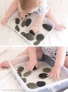 a baby playing with some rocks in the water and on it's back legs