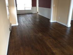 an empty room with hard wood flooring and white trim on the walls is shown