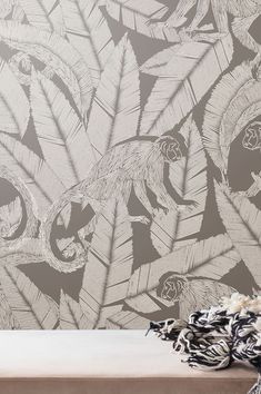 the wallpaper in this room is made up of different types of feathers and leaves