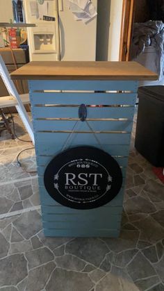 a blue wooden box with a sign on the front that says rst kohle