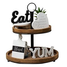 three tiered tray with letters and plants on it