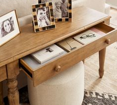 a wooden table topped with pictures and books