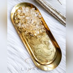 a gold tray with some crystal stones on it