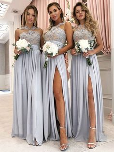 three bridesmaid posing for the camera with their dresses in grey and white colors