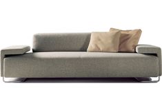 a gray couch with two pillows on it's back and one pillow on the arm