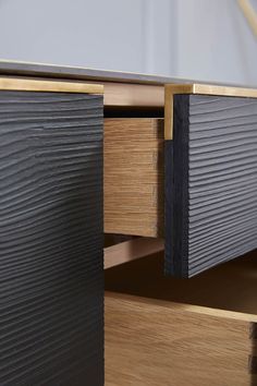 a close up of a drawer with metal and wood trimmings on the drawers