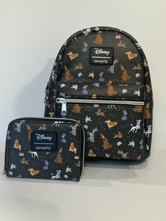 NWT Loungefly Disney Dogs Mini Backpack And Matching Zipper Wallet    Disney Dogs Mini Backpack And Matching Zipper Wallet Set    * Loungefly  * Brand New With Tags   Can't just pick one fave Disney dog? Same! Thankfully this mini backpack has a whole bunch. Printed all over with doggos from Lady and the Tramp, 101 Dalmatians, Oliver and Company and The Fox and the Hound. Featuring a front zipper pocket, inner slip pocket, top carrying handle and adjustable straps.   9" x 5" x 10 1/2" Polyuretha Bounding Outfits, Lounge Fly, Dog Lounge, Disney Loungefly, Oliver And Company, Disneyland Outfits, Disney Bounding, Disney Dogs, Dalmatian Puppy