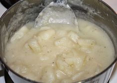 a silver pot filled with food on top of a stove