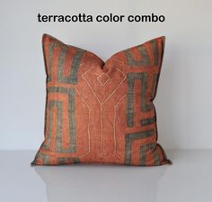 an orange and black pillow with the words terracotta color combo written on it