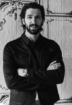 a black and white photo of a man with his arms crossed