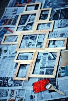 the wall is covered in newspapers and pictures, including an easel with paintbrushes on it